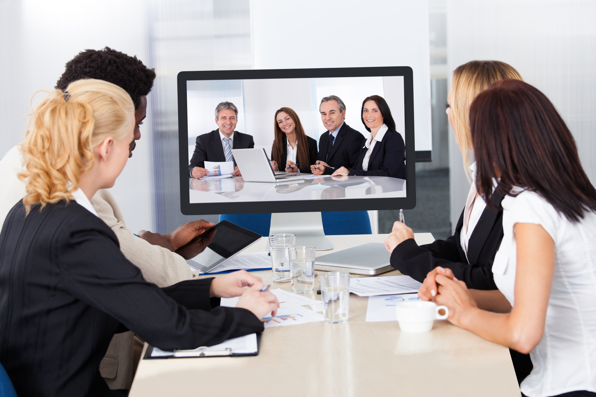 Group of male and female businesspeople at video conference