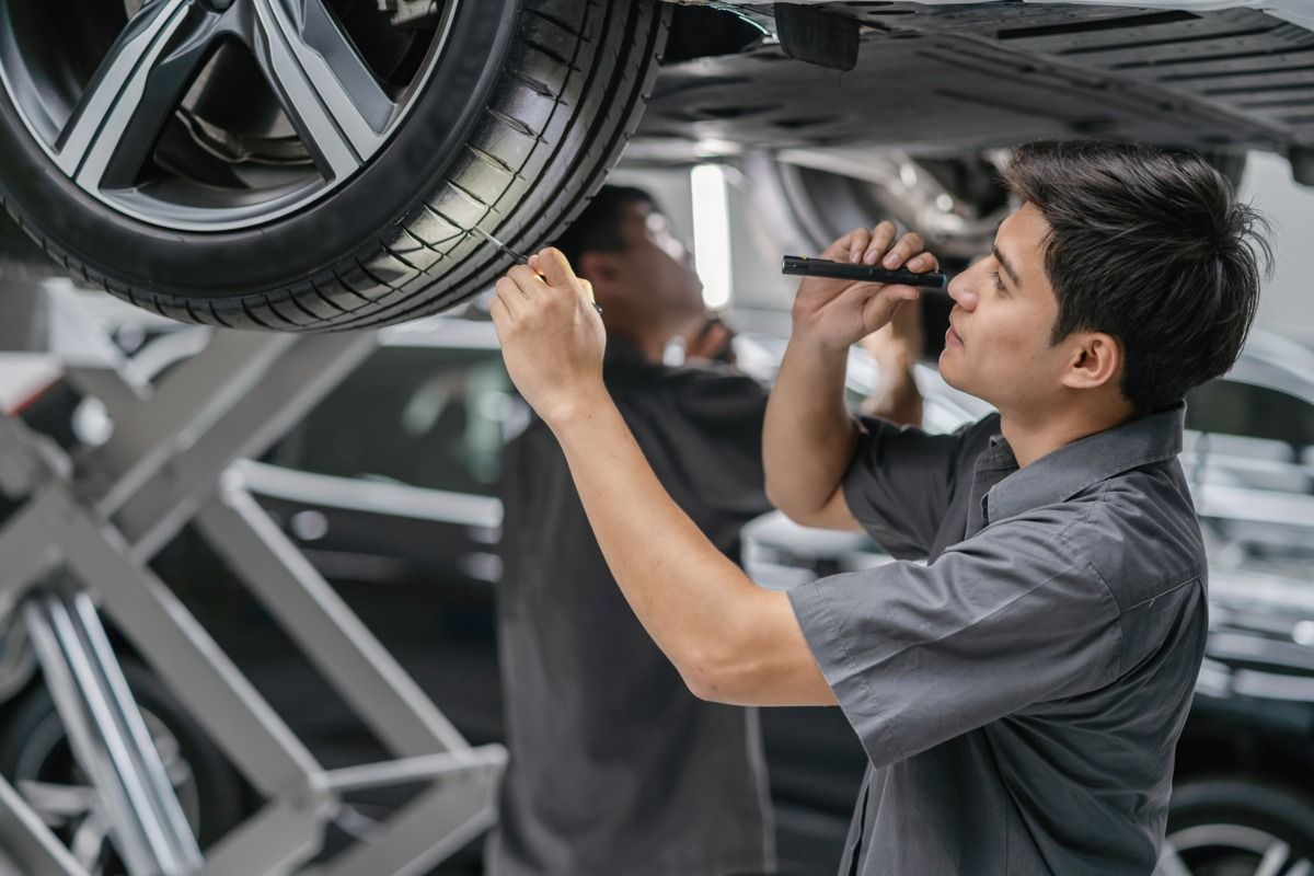 A mechanic checking tire tread depth