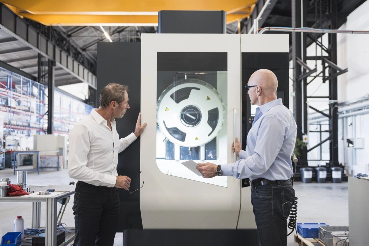 Two professionals work on an aerospace automotive model in a lab