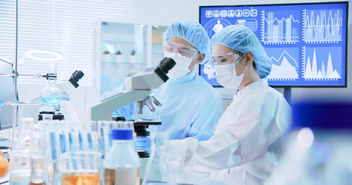 tfs-dqs-two asians at the microscope in the chemistry lab